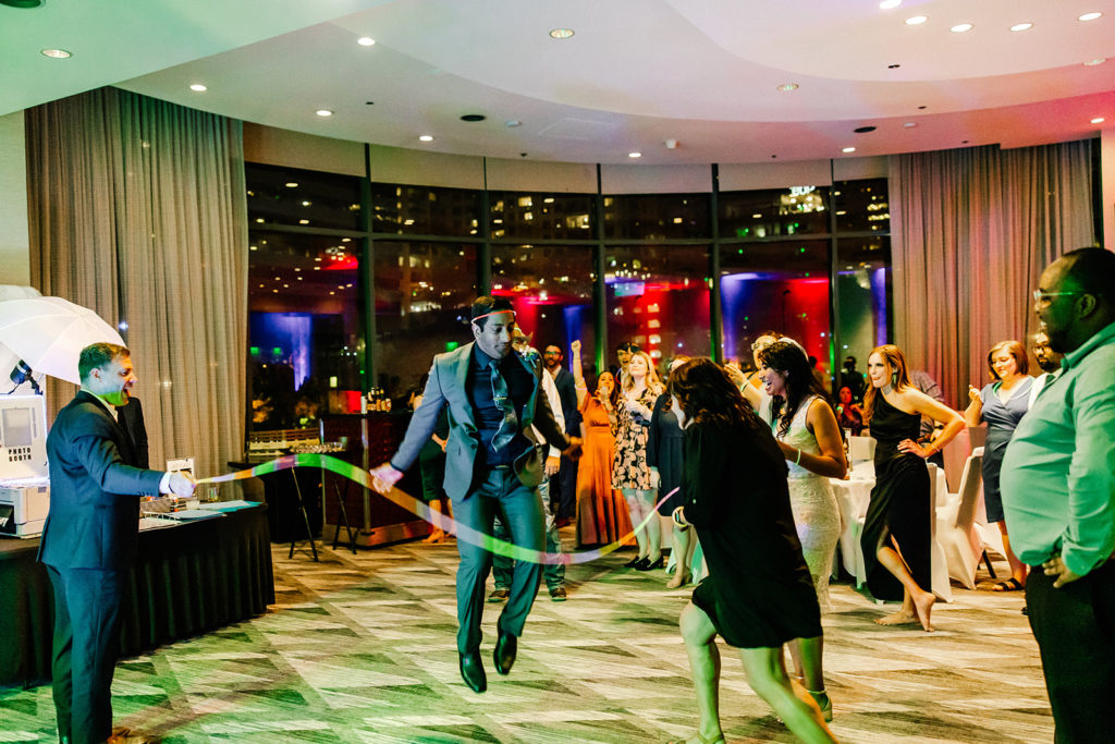 groom jump roping with their wedding party prop glow sticks