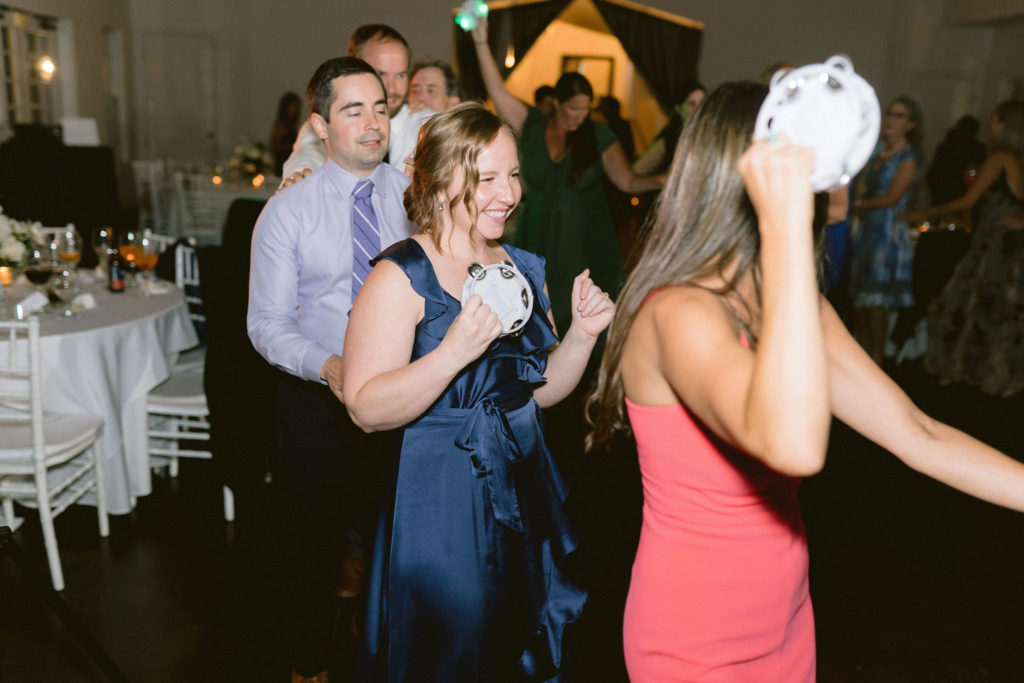 guests enjoying light up tambourines for the couple's wedding party prop for their dance floor 