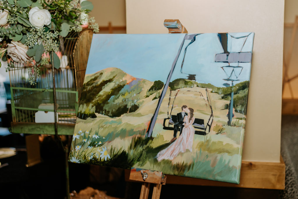 Colorado live wedding painter painting of the couple sitting on the gondola enjoying the intimate moment